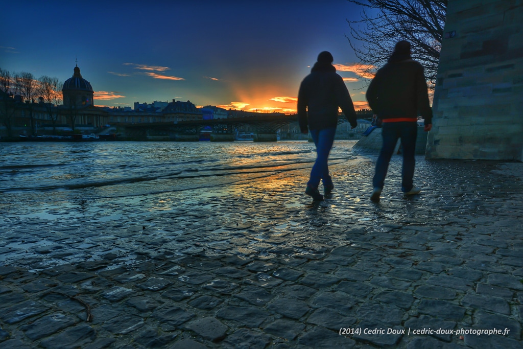 Touristes marchent sur les pavés des quais de Seine à Paris